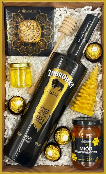 Zestaw prezentowy z wódką Żubrówka Czarna, miodem wielokwiatowym, pralinami Ferrero Rocher i świecą z wosku pszczelego.